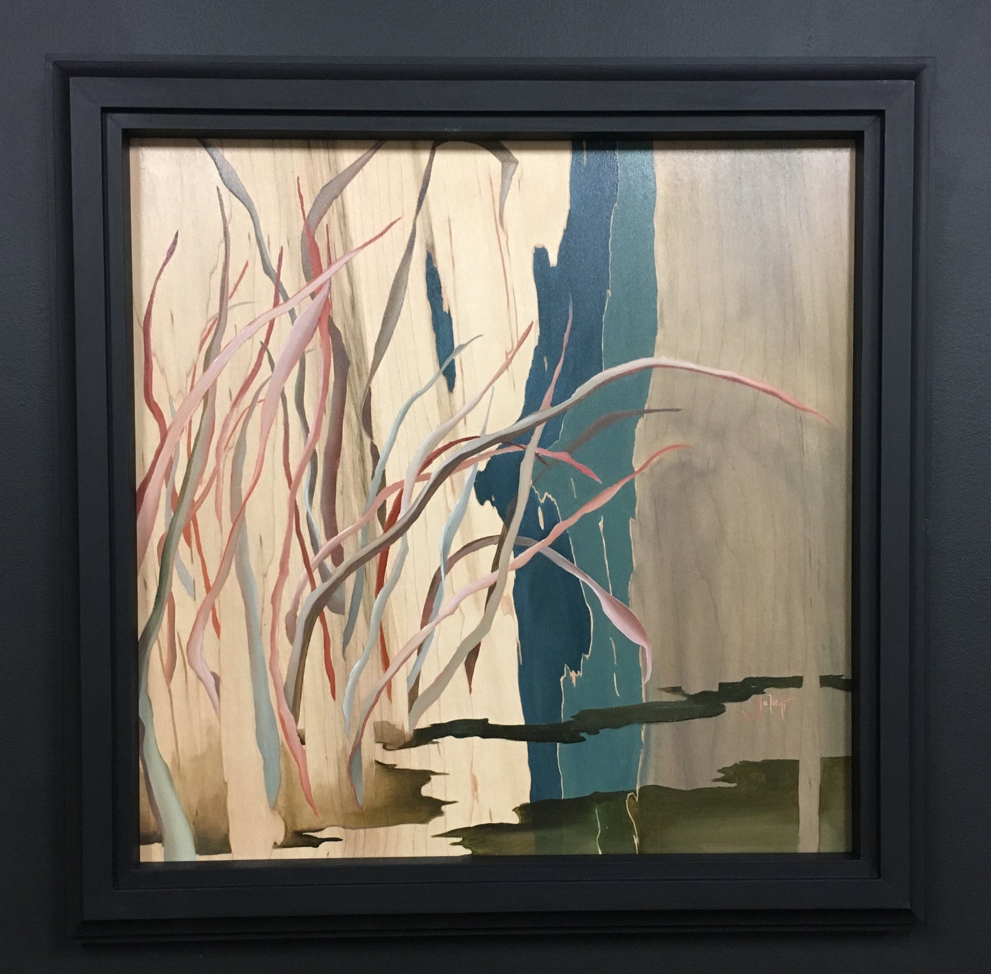 Framed artwork of a silhouette among abstract branches