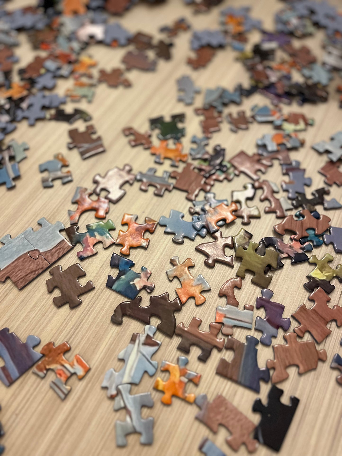 Jigsaw puzzle pieces on a wooden surface